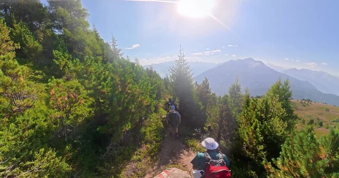 Hiking group on alpine trail from Gogles Alm toward Pitztal Austria