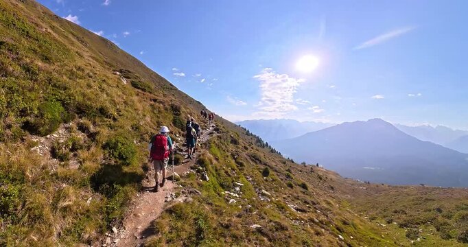Hiking group on alpine trail from Gogles Alm toward Pitztal Austria