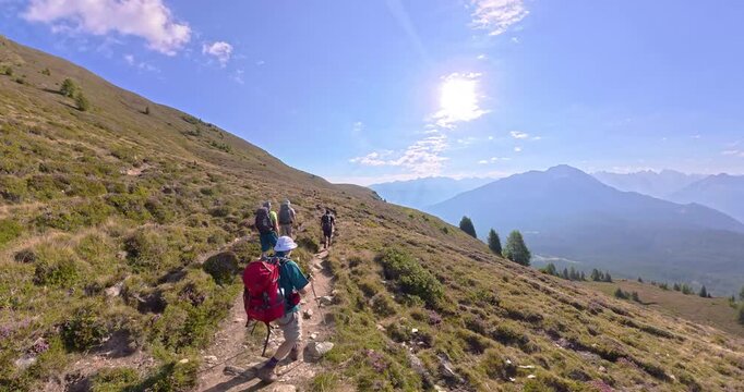 Hiking group on alpine trail from Gogles Alm toward Pitztal Austria