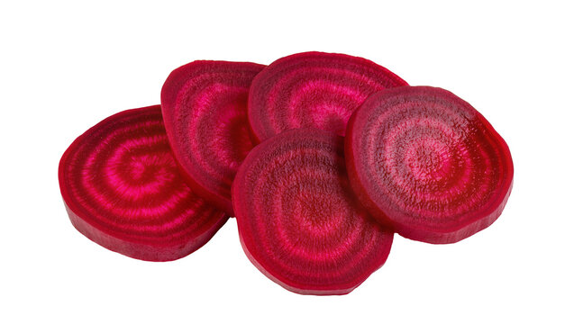 Sliced raw beetroots arranged in a pile, showing concentric rings