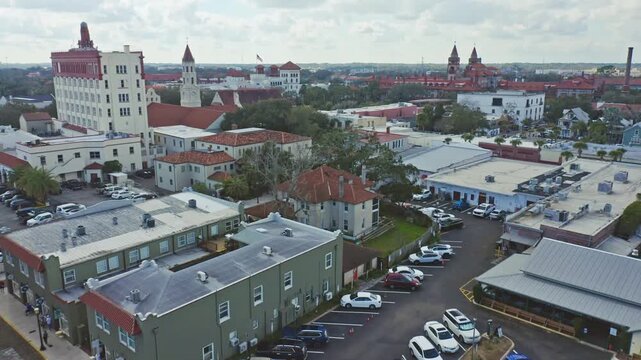 St. Augustine showcasing a mix of historic and modern buildings under a cloudy sky. Ideal for urban development studies or architectural features.