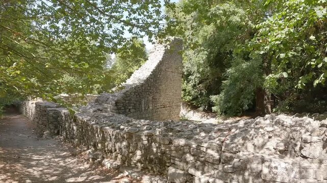 Ancient Byzantine stone ruins, walls and brick arches at historic archaeological site of Butrint National Park in Albania.