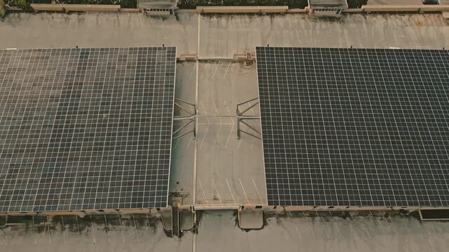 Large photovoltaic array canopies collecting clean solar energy for local hydrogen production facility mounted over concrete parkade lanes captured via reverse ascending tracking drone flight