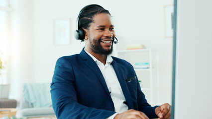 Fototapeta premium Happy, black man and consultant with headset on computer for online finance advice in office. Businessman, agent or financial advisor with smile or mic for virtual assistance or support in workplace