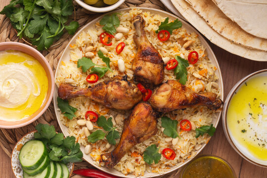 A traditional Arabian rice dish, specifically Chicken Mandi or Kabsa.