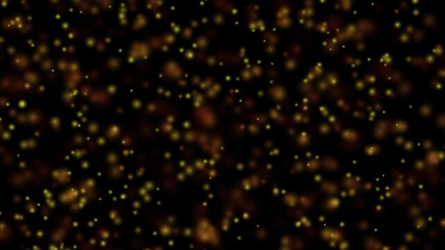 Golden sparkles float against a dark background. The particles shimmer softly, creating a magical, festive atmosphere. Perfect for holiday themes