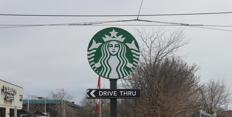 Naklejka premium round pylon sign with Starbucks Coffee Company twin-tailed Siren mascot and Drive Thru located at 23 Leslie St, Toronto