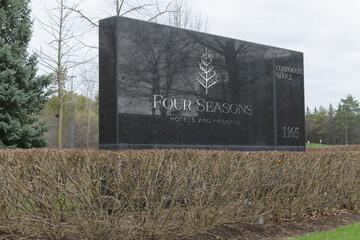 Naklejka premium stone road-side sign outside global headquarters of Four Seasons Hotels at 1165 Leslie St; a Canadian-founded luxury brand managed from Toronto, April 2026
