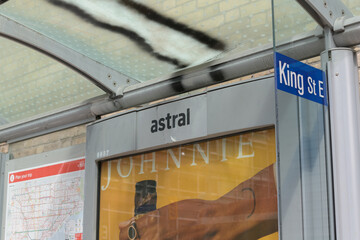 Obraz premium detail of a bus shelter on King St E with out of home advertising for alcohol, and a TTC route map in Toronto