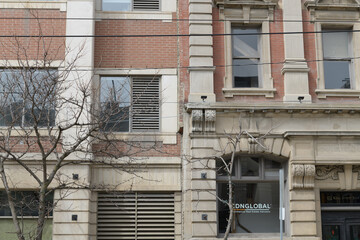 Obraz premium facade and sign of CDNGLOBAL, a brokerage, located at 172 King St E (the historic Sovereign Bank, at right), Toronto