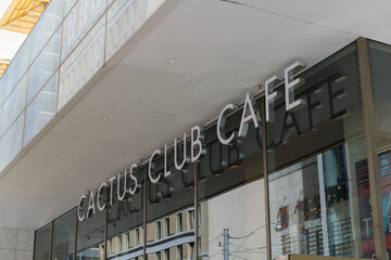 Fototapeta premium exterior building and suspended sign outside Cactus Club Cafe, a restaurant, located at 77 Adelaide St W (First Canadian Place), Toronto