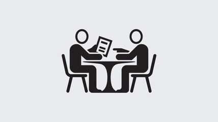 Fototapeta premium Two people sitting at a table discussing a document in a meeting