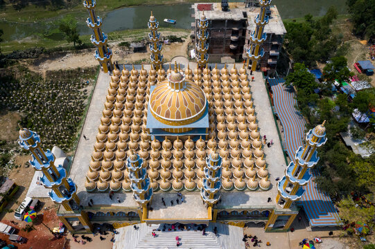 Aerial view of the grand 201 Dome Mosque stands majestically with its golden domes and intricate blue minarets, Tangail, Dhaka Division, Bangladesh.