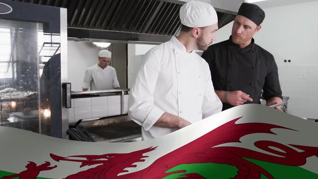 Culinary lead pointing tablet, coordinating line chef prepping while dragon overlay sweeping bottom