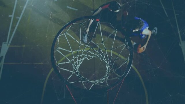 Blue basketball player driving to rim, attempting layup, defender in black jumping, trying to block