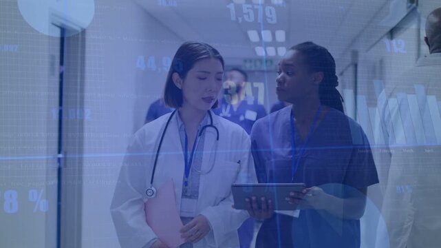 Nurse showing tablet and doctor walking hospital hall, reviewing charts overlaid on tablet for care