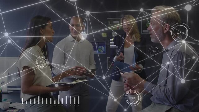 Seated woman presenting notes sparking growing network overlay team on tablet showing business data
