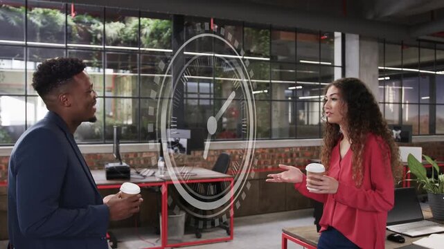 Coworkers holding takeaway cups, chatting in office at red desk, clock overlay rotating over scene