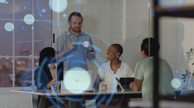 Business team exchanging high-five while celebrating win and reviewing tablet with blue HUD overlay