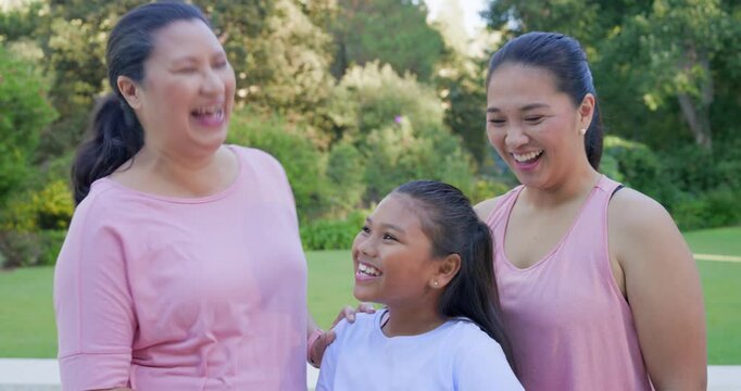 Asian family placing on youth's shoulder, leaning, holding purple mat, posing for camera at pool