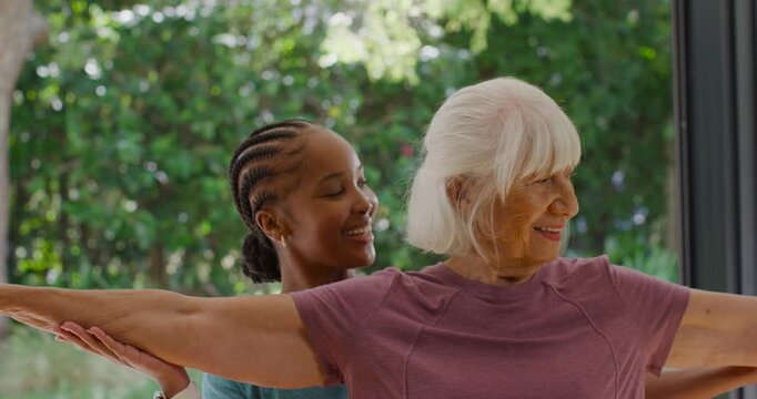 African American woman coach guiding Sr woman, placing hand under arm, aiding balance by glass door
