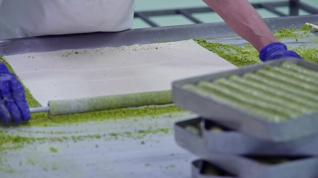borek, borek making, phyllo dough, dough folding, pastry folding, thin dough, layered dough, savory pastry, pastry preparation, tray, tray placement, preparation stage, kitchen, gastronomy, Turkish cu
