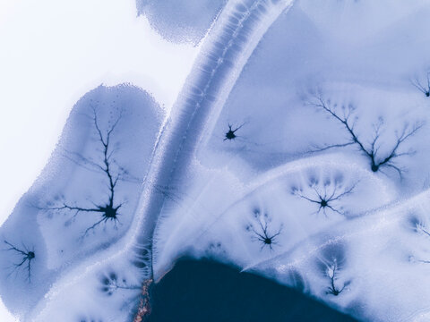 Landscape, tourism: Aerial view of frozen lake with ice patterns resembling trees, winter environment, Fusine lakes, Tarvisio, Friuli, Italy.