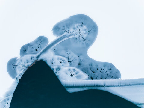 Winter landscape, aerial view of frozen lake with ice patterns, creating a unique nature background, Fusine lakes, Tarvisio, Friuli, Italy.