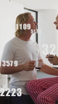 Vertical video: Smiles sparking couple leaning in, seeking kiss, holding mugs with drifting digits