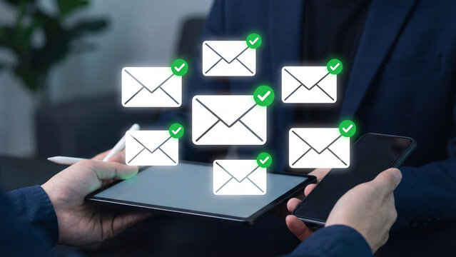 Hands holding digital devices with numerous floating email notification icons.