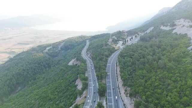 Aerial top-down view of a U-shaped highway curve with traffic