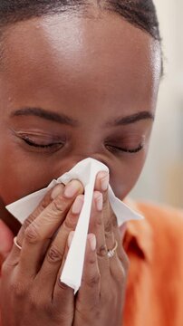 Woman, sneeze and blowing nose in house with tissue, health problem and flu symptoms from burnout. Sick, black person and allergy in home with toilet paper, virus and congestion from sinus infection.
