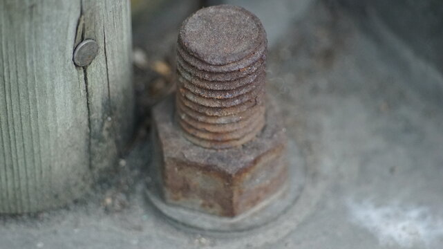 Detailed view of an old oxidized steel bolt with brown rust texture