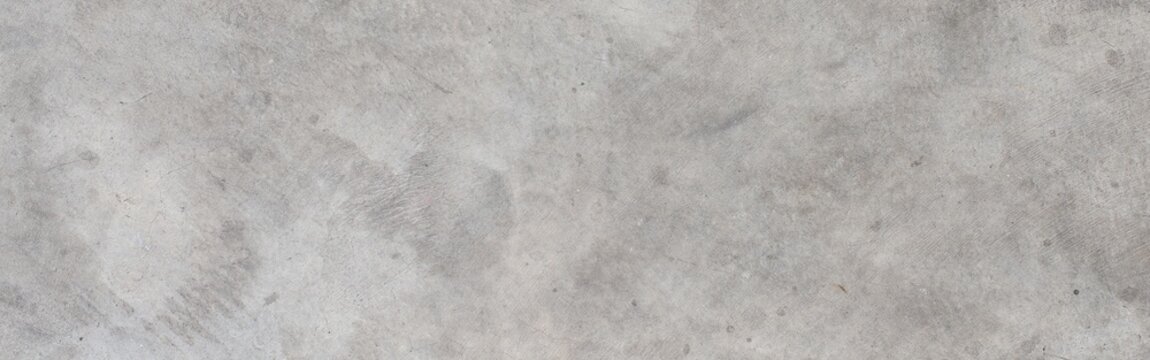 Gray concrete surface forming a textured abstract background, displaying a rough cement wall finish with industrial and rustic details, perfect for architectural design