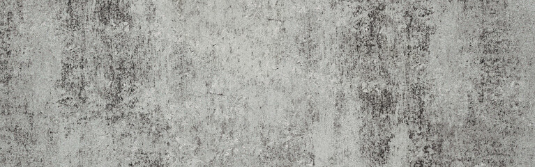 Fototapeta premium Gray concrete wall texture background creating an industrial aesthetic, featuring rough grainy surface patterns with weathered cement details and peeling paint effects