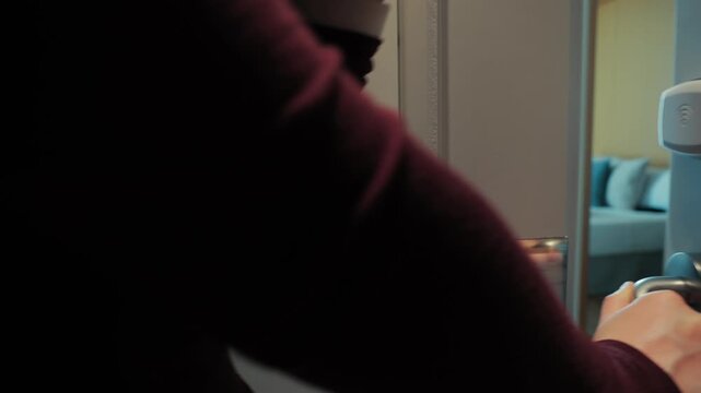 A close-up of a hand touching a hotel key card to open a room. Contactless access highlights modern security technologies and convenience in the hospitality industry. Concept of travel, hotel stays