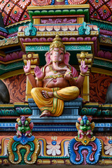 Fototapeta premium Detail of the exterior of the Sri Mariamman Temple, Singapore's oldest Hindu temple, featuring colorful, plaster sculptures of Hindu deities and other ornamental figures and objects.