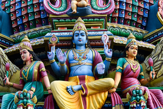 Detail of the exterior of the Sri Mariamman Temple, Singapore's oldest Hindu temple, featuring colorful, plaster sculptures of Hindu deities and other ornamental figures and  objects.