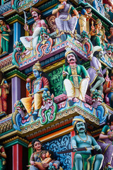 Fototapeta premium Detail of the exterior of the Sri Mariamman Temple, Singapore's oldest Hindu temple, featuring colorful, plaster sculptures of Hindu deities and other ornamental figures and objects.