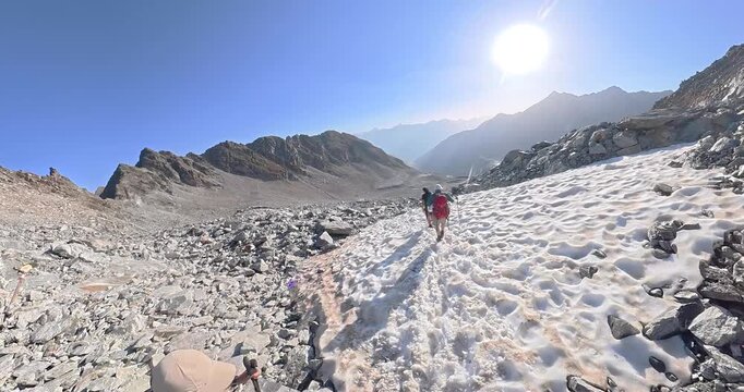 Hiking descent from Pitztaler Jochl to Rettenbach glacier over snowfield