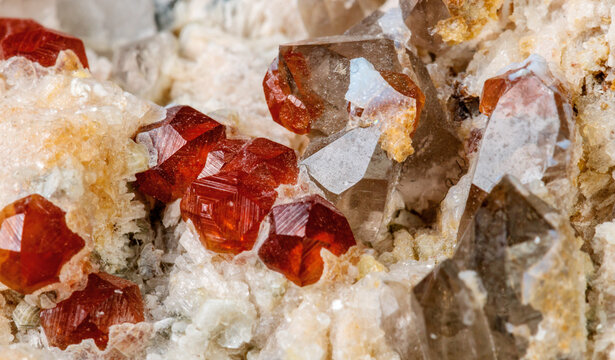 Natural Spessartine Garnet Crystals in Matrix Isolated on White
