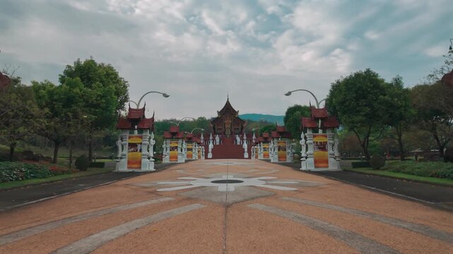 Traditional Thai temple in Rajapruek park with symmetrical pathway and statues in Chiang Mai, Ornate Asian shrine architecture with stairs and cultural landmark in Thailand 4k