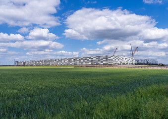Exterior shot of a data center located in Hutto, Texas. under construction besides rolling fields near Austin © steheap