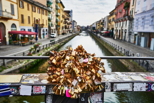 Collection of love locks on a bridge over the Naviglio Grande, one of the historic canals in the Navigli district of Milan, Italy, Europe