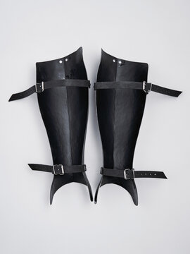 A detailed view of black lightweight armored bracers featuring adjustable buckled straps, perfect for cosplay or reenactment purposes. Ideal for adding authenticity to medieval or fantasy costumes.