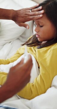 Forehead, girl and thermometer of mother in bedroom of home for checkup, health monitoring or illness. Fever, sick and temperature with daughter in bed for healing, parent care or wellness concern