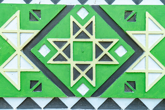 Geometric ornamental pattern with green and white traditional motif for abstract cultural background design.
