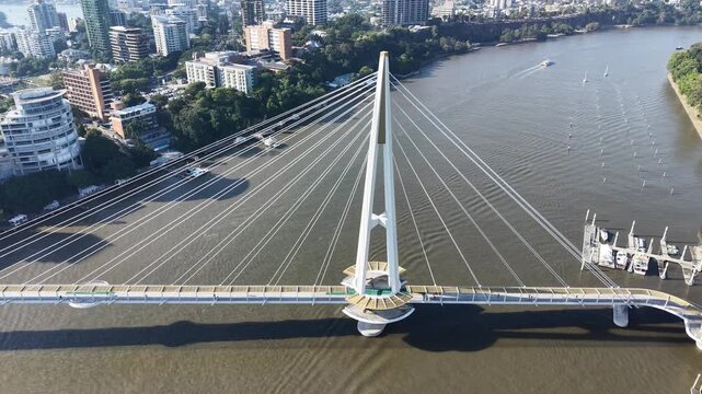 Top-down aerial shot focusing on the main tower of a large urban suspension bridge.