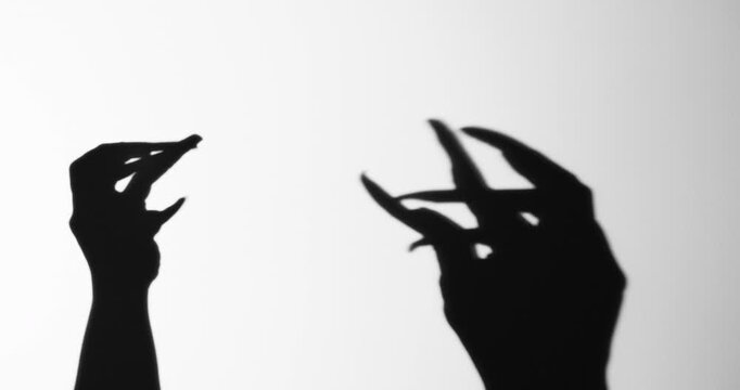 Shadow of a zombie hand on white background
