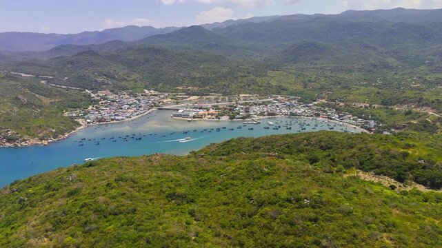 Panoramic Aerial Drone Footage of Vinh Hy Bay with Turquoise Water and Forested Hills Ninh Thuan Province Vietnam